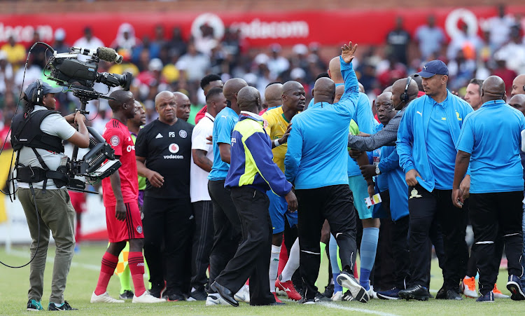 Mamelodi Sundowns' coach Pitso Mosimane is restrained by captain Hlompho Kekana during a fracas with the Orlando Pirates' bench in an emotionally charged Absa Premiership encounter at Loftus Versfeld on Saturday November 10 2018.