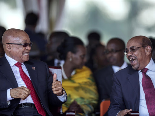 South African President Jacob Zuma laughs with Sudan's Hassan al-Bashir during the swearing-in ceremony of Uganda's president Yoweri Museveni at the Kololo independence grounds in Kampala, Uganda, May 12, 2016. Photo/REUTERS