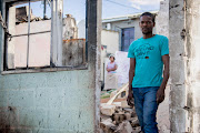 Elias Xalipi in the remains of his house in Knysna's White Location. / Anthony Molyneaux