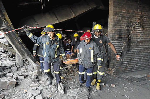 Johannesburg Emergency Services personnel at Power Park in Soweto remove an injured man from the rubble of the old Orlando power station which caved in when one too many metal supports was removed. File photo