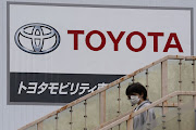 Toyota is slowing production at its plants in Japan because of rising Covid-19 infections among its workers.