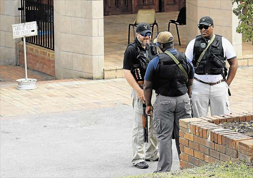 Armed guards stand at the door of an exam venue at Rhodes University in Grahamstown yesterday Picture: SILUSAPHO NYANDA