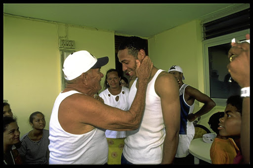 Theirry Henry greets his grandfather at the family home on La Désirade, Guadeloupe.