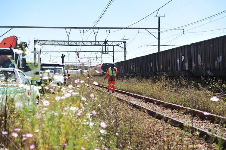 Workers from Transnet fix a section of a railway in Springs, Ekurhuleni, where a 1km copper cable was stolen. Picture: THULANI MBELE
