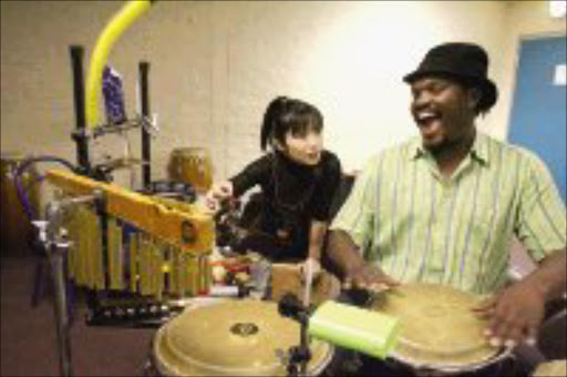 TRANS-RHYTHM: Jazz pianist Keiko matsui with percussionist Tlale Makhene in Newtown, Johannesburg, yesterday. Pic. Mohau Mofokeng. 12/09/07. © Sowetan.