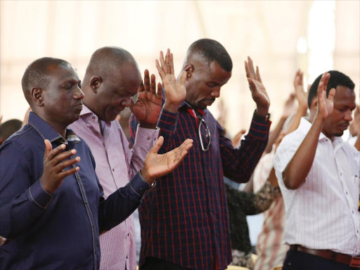 let’s pray: DP William Ruto and Kilifi North MP Gideon Mung’aro pray during a church service at JCC, in Bamburi, Mombasa.