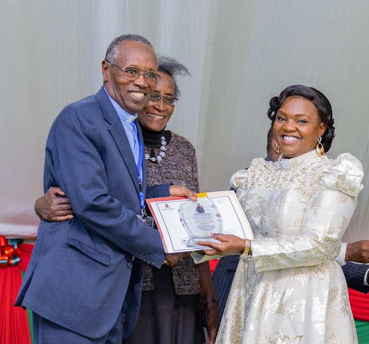 Pastor Dorcas Rigathi hands the certificate and award of service to Rev. Dr. Macmillan Kiiru at Eldoret, who is together with the wife, during the Heroes and Heroines Awards 2024 on 12th April 2024.