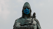 The monument of Tezozomoc is seen with a face mask that reads 