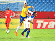 Mamelodi Sundowns' Wayne Arendse, who scored the opening goal, is challenged by Mbondi Christ of Rayon Sports  during last night's CAF Champions League eliminator at Loftus Versfeld. Downs won 2-0 to qualify for the group stages. 