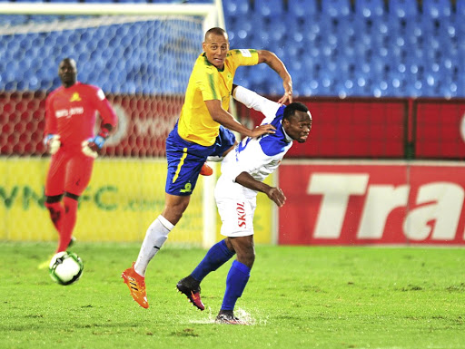 Mamelodi Sundowns' Wayne Arendse, who scored the opening goal, is challenged by Mbondi Christ of Rayon Sports during last night's CAF Champions League eliminator at Loftus Versfeld. Downs won 2-0 to qualify for the group stages.