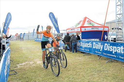 PEDAL POWER: East London mountain biker Eben Hartslief pumps his fist in delight as he just edges out Jason Meaton on the line to win the Daily Dispatch Mountain Bike Challenge at Wings Park yesterday Picture: SINO MAJANGAZA
