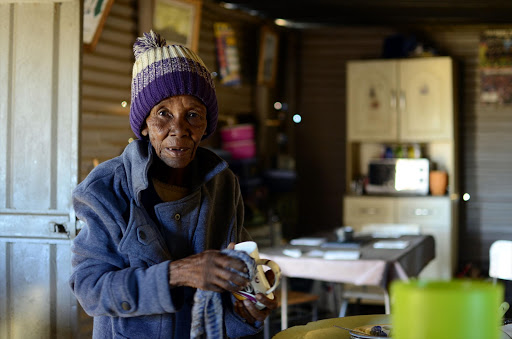 Maria Molelekeng washes dishes in her shack in Itekeng, a township at Biesiesvlei, North West. The community are protesting about their living conditions. / Tiro Ramatlhatse