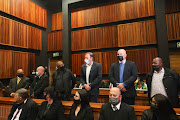 In the dock at the specialised commercial crimes court sitting in Palm Ridge magistrates court in May are, from left, Kuben Moodley, Eric Wood, Siyabonga Gama, Garry Pita, Daniel Roy and Phetolo Ramosebudi. File photo.