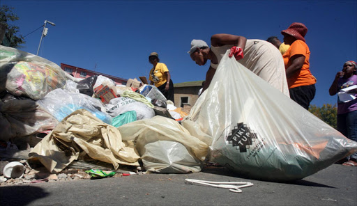 Alexandra residents clearing the streets during the strike by municipalities workers in Johannesburg. PHOTO: ANTONIO MUCHAVE