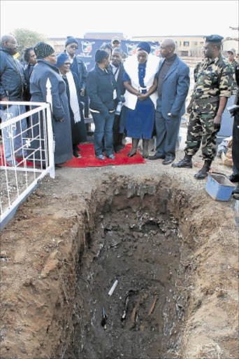 HEARTBROKEN: Family members of MK cadres are comforted as bodies of their relatives are exhumed at the Old Mmabatho Cemetery in Mahikeng on Friday.