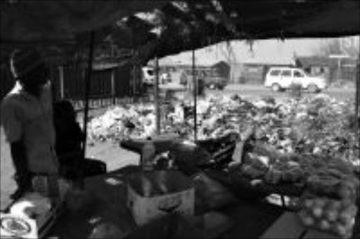 HEALTH HAZARD: Uncollected rubbish is pilling up at street corners and pavements in Thembisa because of the ongoing Samwu strike that has besieged the township. Pic. PAT SEBOKO. 03/09/2009. © Sowetan.