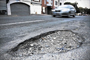HOLEY CITIES: The State is obliged to maintain facilities such as roads, but potholes the size of fishponds are a common sight on South Africa roads - a sign of failure to carry out what the State is meant to do. Photo: Daniel Born