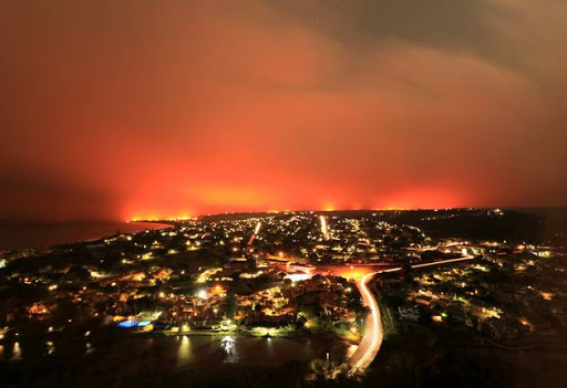 Wildfires burn near Plettenberg Bay, South Africa, June 8, 2017. Strong winds fanned fires destroyed houses and prompted the evacuation of thousands of residents in nearby Knysna. Picture taken June 8, 2017.