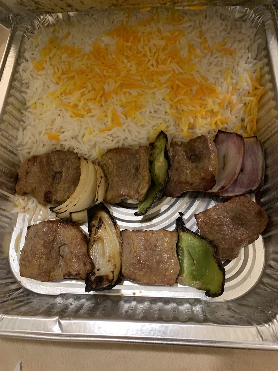 Lamb kabob with rice. Tomato in separate container.