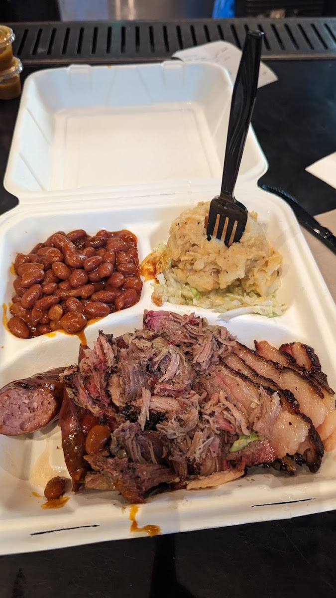 3 meat platter with beans and potato salad