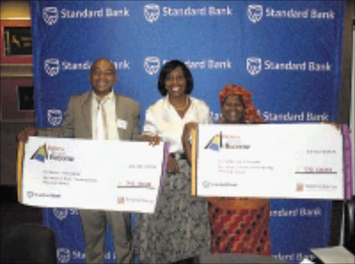 ALL SMILES: Ezekiel Madigoe, Tina Eboka, of Standard Bank, and Lemogang Aurelia Lehabe. 13/04/09. Pic. Penwell Dlamini. © Sowetan.
