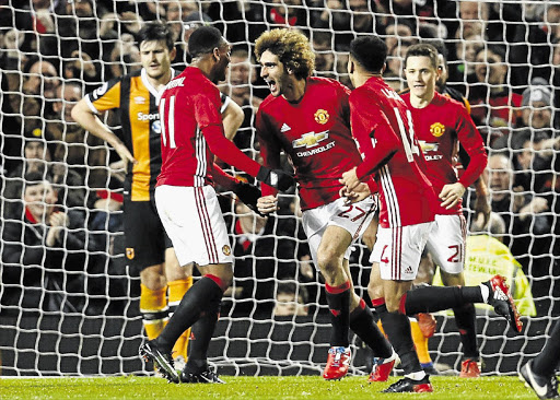 LET THE GOOD TIMES ROLL: Manchester United's Marouane Fellaini celebrates their second goal against Hull City in the EFL Cup semifinal first leg at Old Trafford on Tuesday.