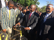 President Cyril Ramaphosa hands a bike to Mandela School of Science and Technology pupil Malunga Mputha on July 18, 2018. 
