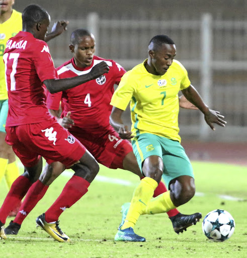 Bafana's Lebohang Maboe dribbles past Itamunua Keimuine and Welwin Gebhardt of Namibia.