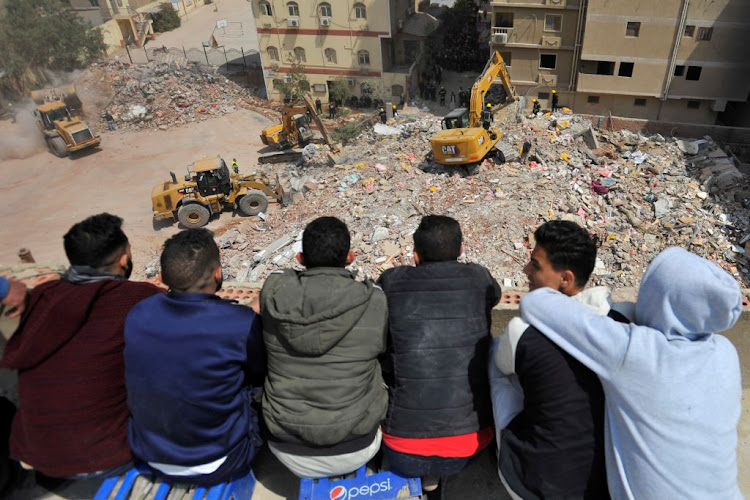 Rescuers work at the site where a building collapsed in Gesr al-Suez, Cairo, Egypt, on March 27 2021.