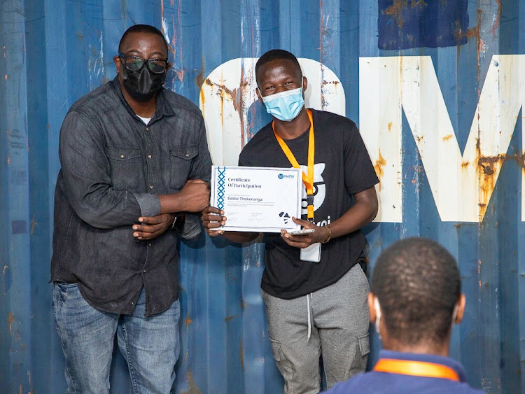 Benon handing over a certificate of participation