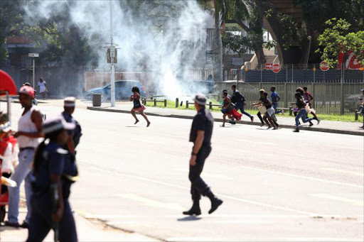 Unisa students ran rampant through the Durban city centre‚ stoning cars and overturning bins during a tense stand-off over fees. Picture:THULI DLAMINI