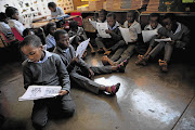 Pupils read from photocopies at Rutandale Primary School in Thohoyandou, Limpopo, in this file photo from 2012 because their textbooks had not been delivered halfway into the year.