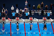 Swimmers compete in the women's 4x100m medley relay heats in Doha on Sunday. 
