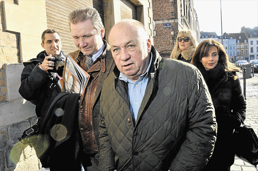 DATE WITH THE DOCK: Belgian Dominique Alderweireld, foreground, is one of the 14 defendants in the so-called 'Carlton Case' trial in Lille, France. One of his co-defendants is former IMF chief Dominique Strauss-Kahn, who is accused of being part of a prostitution ring four years after a sex scandal cost him his career
