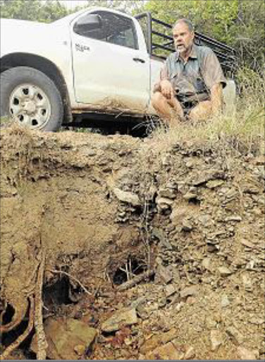 NOT HAPPY: Shaw Park farmer Coert Herbst parks next to a massive donga that is eating away the road near his farm making it dangerous to travel on