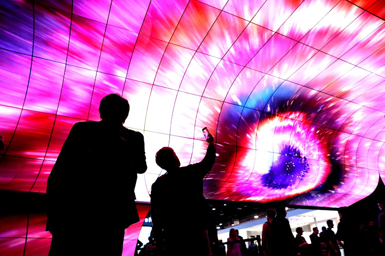 Attendees watch a display during CES 2023, an annual consumer electronics trade show in Las Vegas, US.