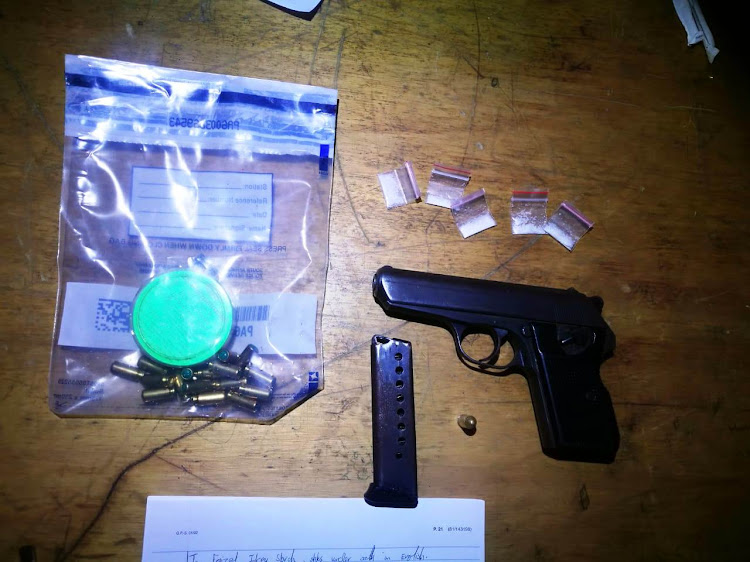 A pistol, ammunition and drugs seized in raids by the anti-gang unit on the Cape Flats