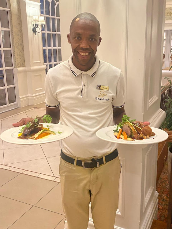 The Boardwalk's Lulama Shesheju serves the main course at Kipling's at the Boardwalk on Valentine's Day