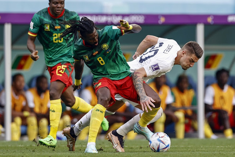Andre-Frank Zambo Anguissa of Cameroon challenges Sergej Milinkovic-Savic of Serbia in the World Cup Group G match at Al Janoub Stadium on November 28 2022.