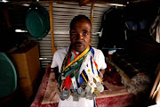 Soweto car guard and athlete Khubulani Zondo with his medals.