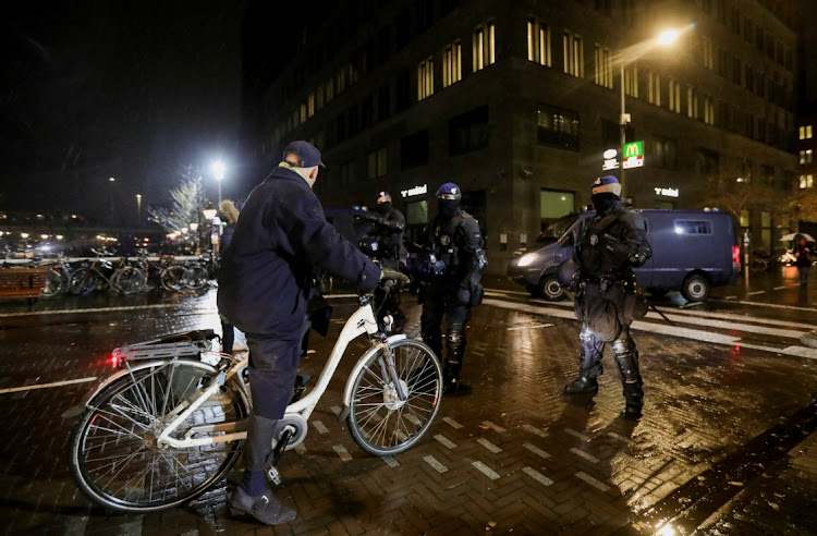 Police officers stand guard following Dutch Prime Minister Mark Rutte's announcement of new measures to fight a record surge in coronavirus disease (Covid-19) infections, in The Hague, Netherlands, November 26, 2021.