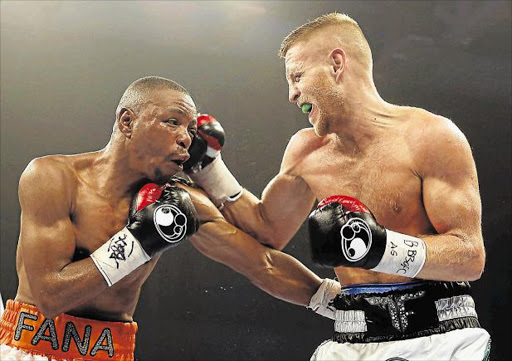 COMPETITIVE VETERAN: Terry Flanagan of Great Britain, right, connects with a right to the head of the ageless Mzonke Fana of South Africa during their WBO World Lightweight Championship bout at the Ice Arena in Cardiff. Fana is now considering hanging up his gloves Picture: GETTY IMAGES