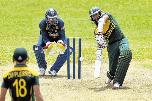 CENTURION: Hashim Amla plays a shot, with Sri Lankan Dinesh Chandimal behind the wicket, during a warm-up match yesterday between a President's XI and South Africa in Colombo. South Africa will play three ODIs and two Tests in Sri Lanka between Sunday and July 28