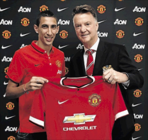 BIG FISH: Manchester United's Angel di Maria poses with manager Louis van Gaal at Aon Training Complex in Manchester on Tuesday Photo: John Peters/ Getty Images