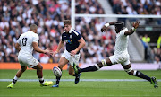 Scotland's centre Huw Jones (C) vies with England's centre Jonathan Joseph (L) during the Six Nations international rugby union match between England and Scotland at Twickenham stadium in south west London on March 11, 2017.