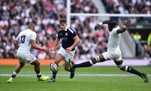 Scotland's centre Huw Jones (C) vies with England's centre Jonathan Joseph (L) during the Six Nations international rugby union match between England and Scotland at Twickenham stadium in south west London on March 11, 2017.