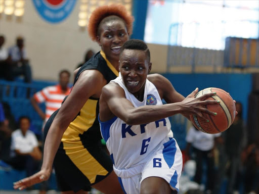 Natalie Akinyi (L) of KPA under pressure from Mercy Nanyama of Equity Bank during their finals game four play-offs at the Nyayo National Stadium gymnasium on February 12, 2017. KPA won 67-62. /Jack Owuor