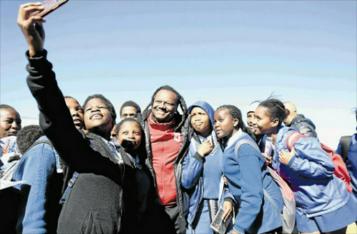 GUIDANCE: Soccer legend Jabulani Mendu takes selfies with pupils from Vulamazibuko High school in Mdantsane during their visit to the school yesterday. Picture: SIBONGILE NGALWA