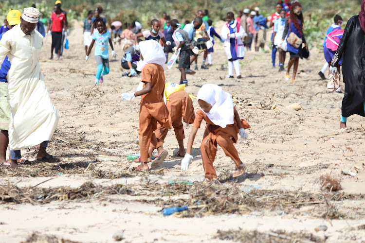 Stakeholders take part in the Malindi monthly clean up exercise organised by Pwam at the Casino beach in Malindi.
