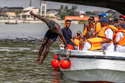 Akinrodoye Samuel jumps into the water to start his 11.8km 'Swim Against Suicide And Depression' in Lagos, Nigeria, on March 30 2024.
